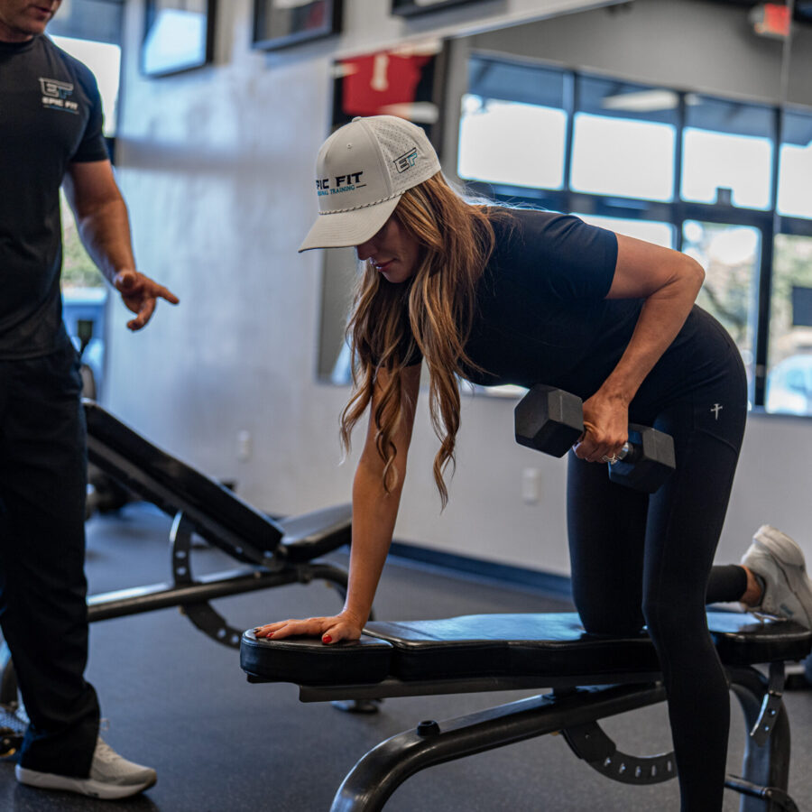 A personal trainer leads a high-intensity workout in a gym.